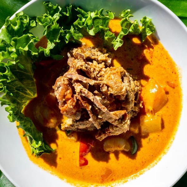 Crispy soft-shell crab in a rich red curry sauce with vegetables and fresh lettuce.