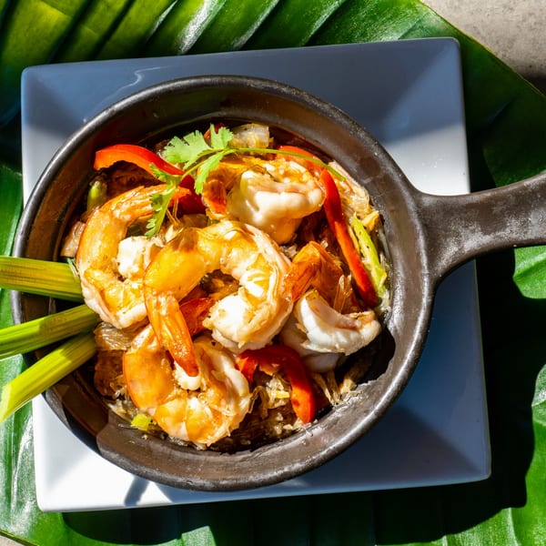 Thailicious's shrimp and glass noodles with red peppers and cilantro in a black pan.